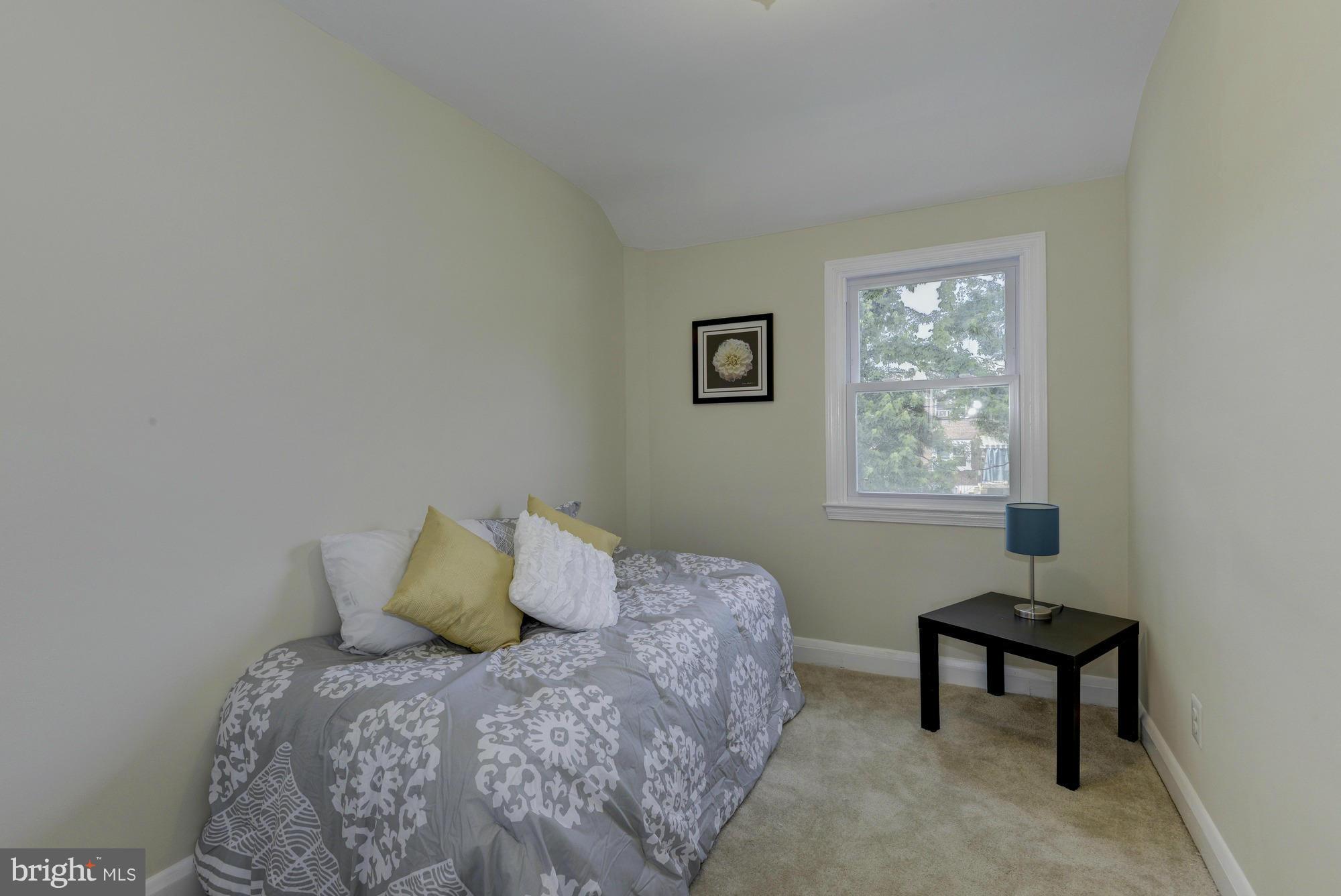 1901 Swansea Road Baltimore, MD 21239 - Photo 21 of 28 a bedroom with a bed a painting and a window