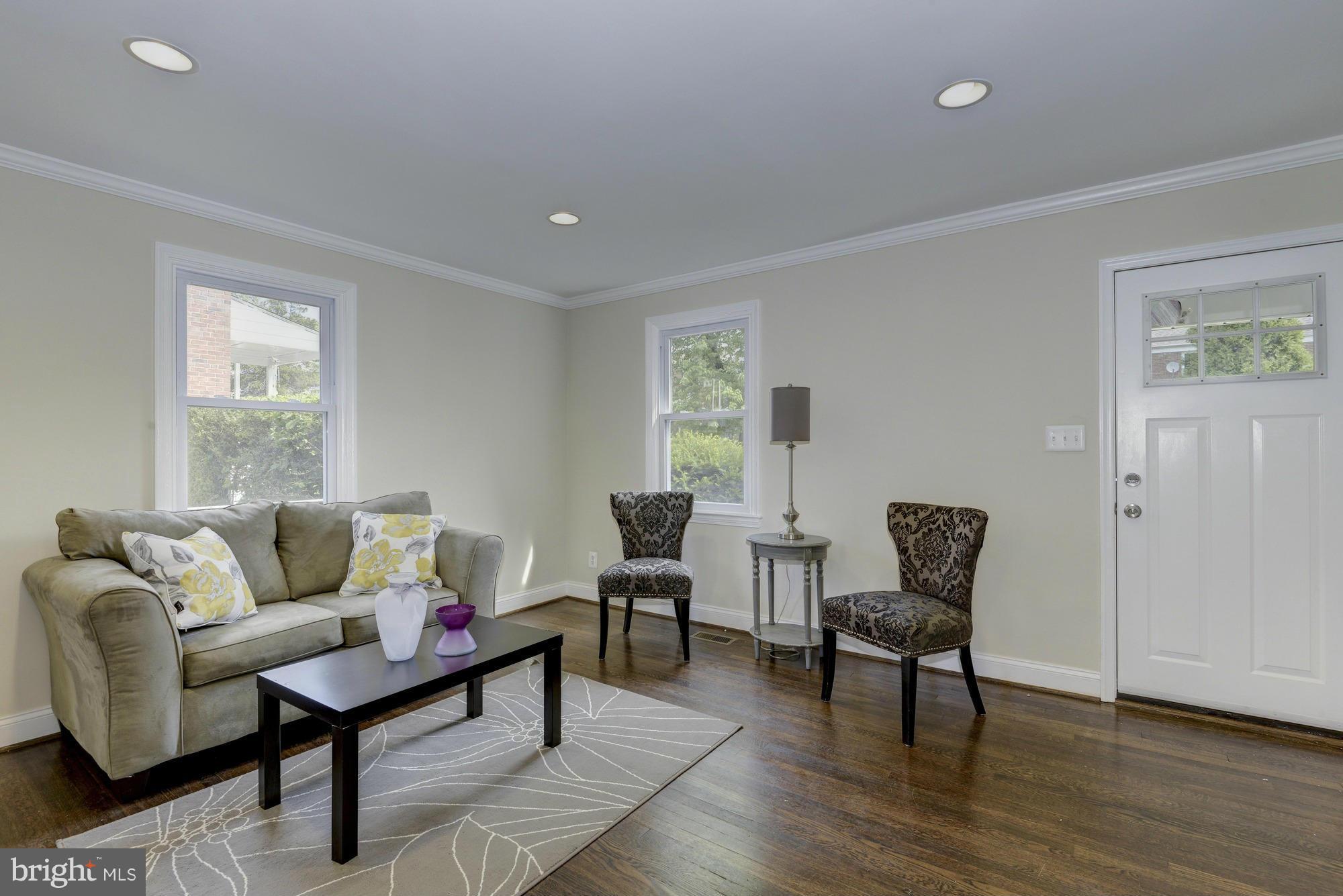 1901 Swansea Road Baltimore, MD 21239 - Photo 6 of 28 a living room with furniture and a potted plant next to a window