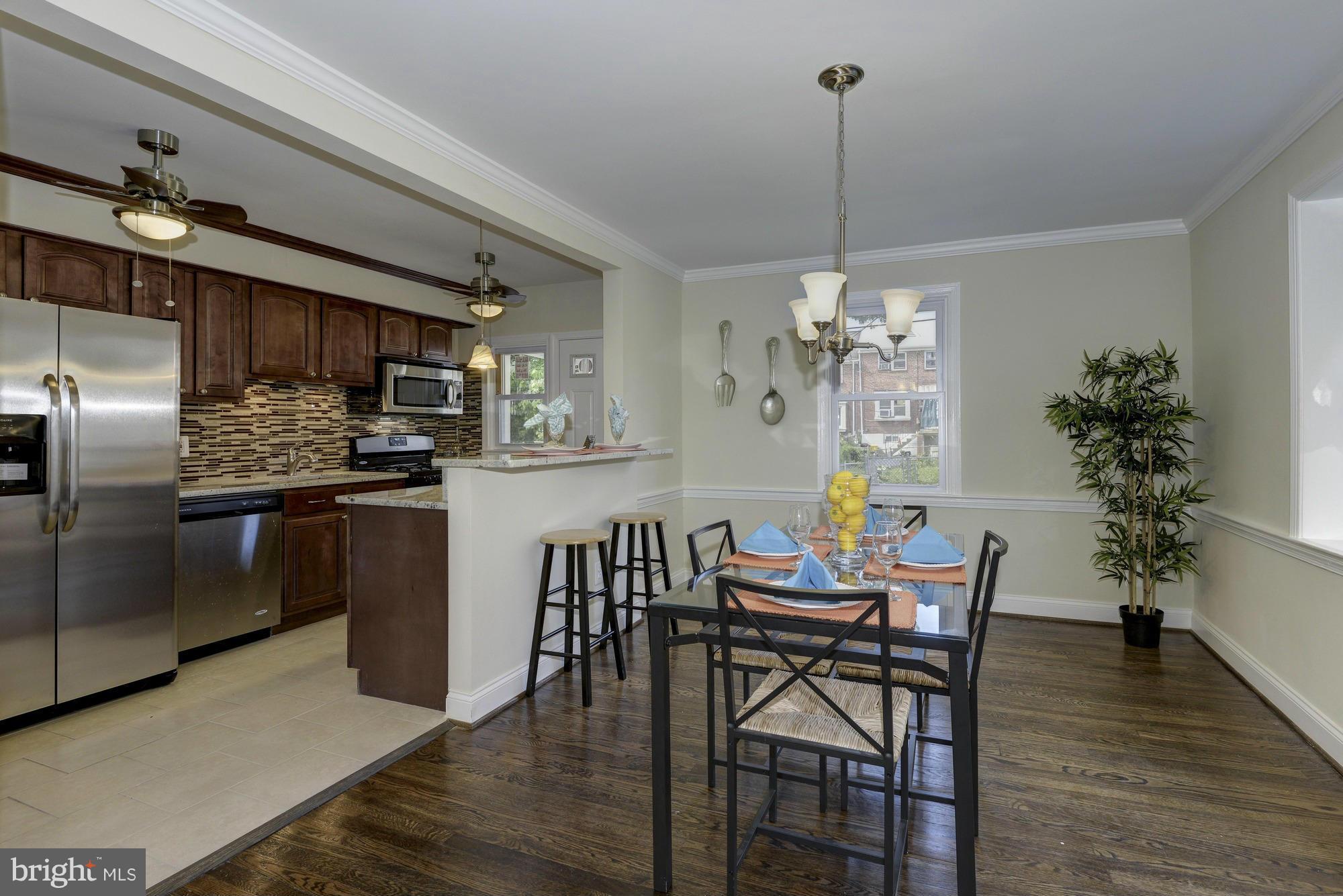 1901 Swansea Road Baltimore, MD 21239 - Photo 8 of 28 a view of a dining room with furniture wooden floor and chandelier