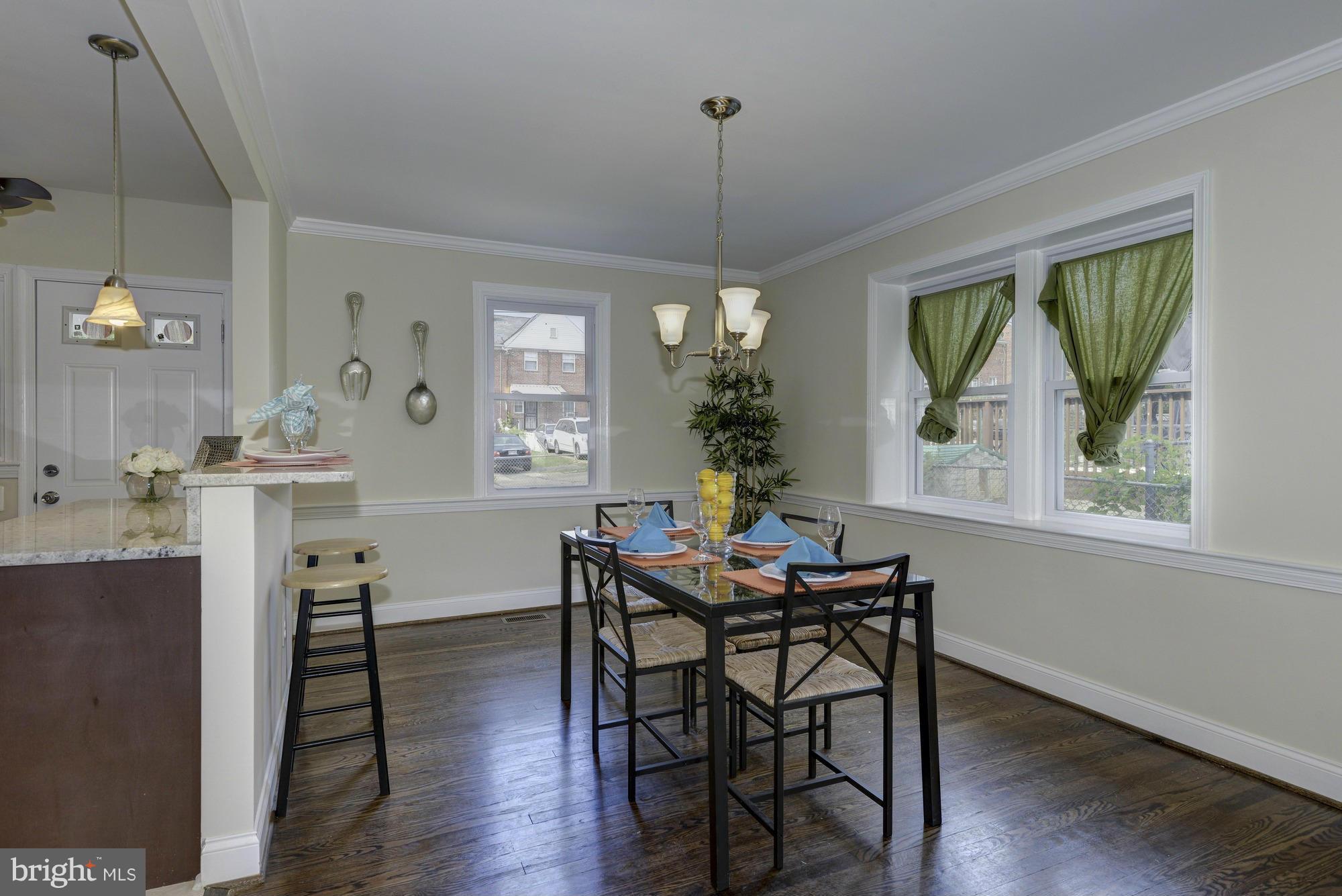1901 Swansea Road Baltimore, MD 21239 - Photo 9 of 28 a view of a dining room with furniture window and wooden floor