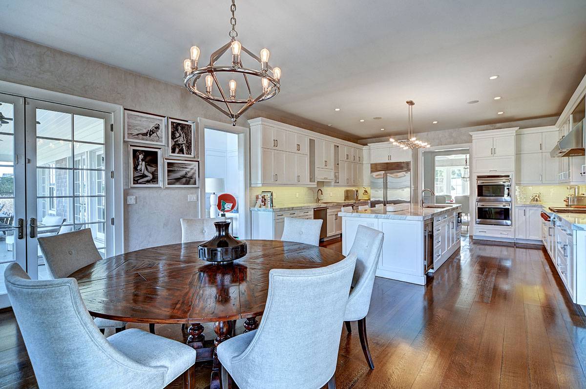 63 Newlight Lane Bridgehampton, NY 11976 - Photo 11 of 37 a view of a dining room with furniture a chandelier and wooden floor