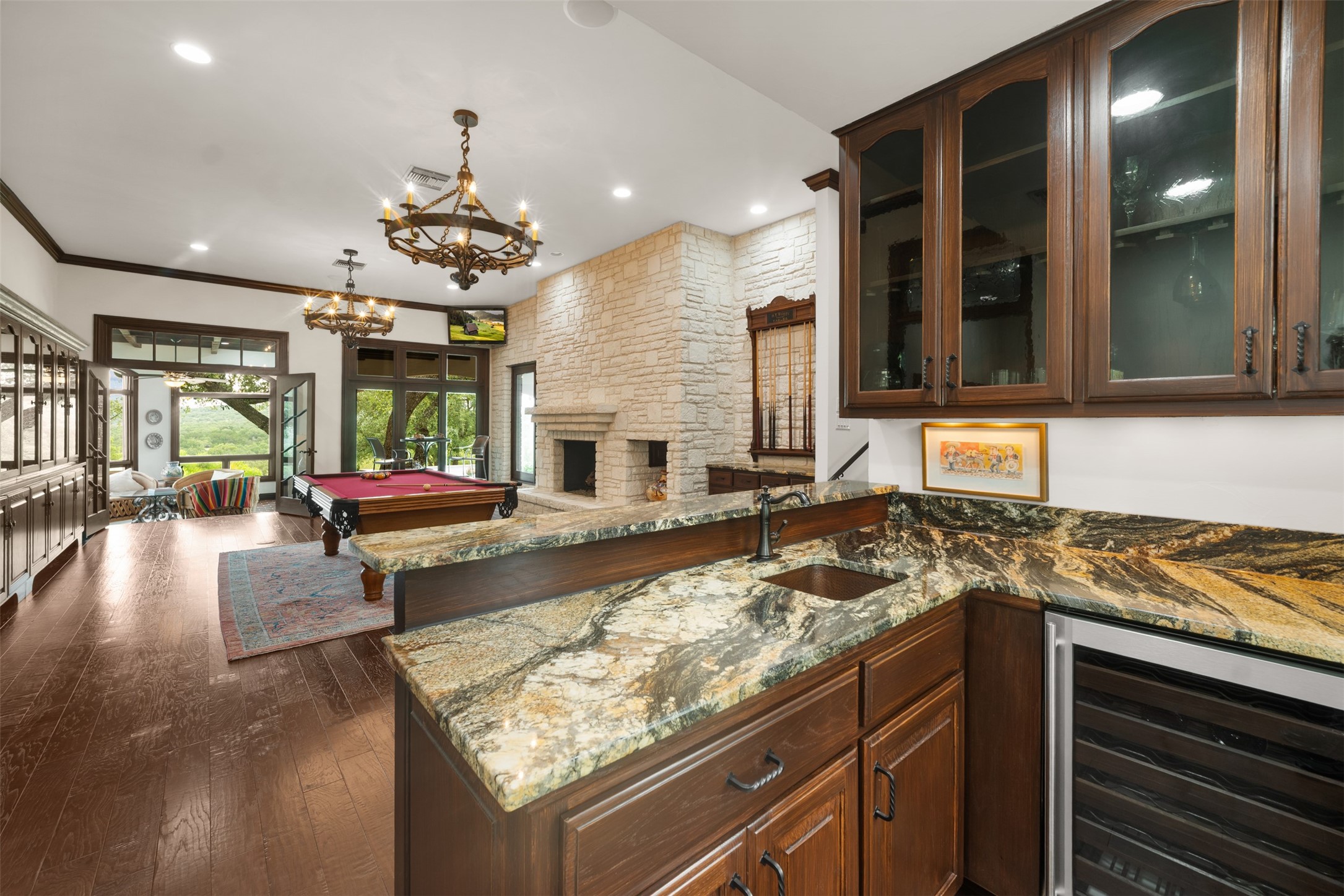 34000 Smithson Valley Road Bulverde, TX 78163 - Photo 16 of 50 A beautifully appointed wet bar with granite countertops, custom cabinetry, and beverage refrigeration serves the adjacent game room. Ideal for hosting gatherings and game-day celebrations.
