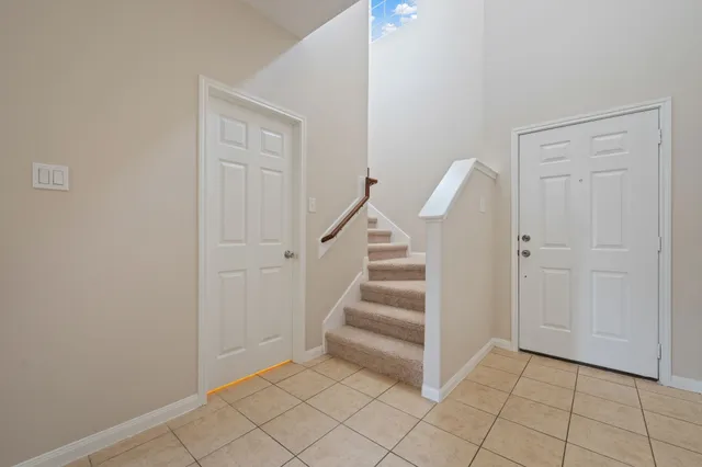 a view of a livingroom with white walls and stairs