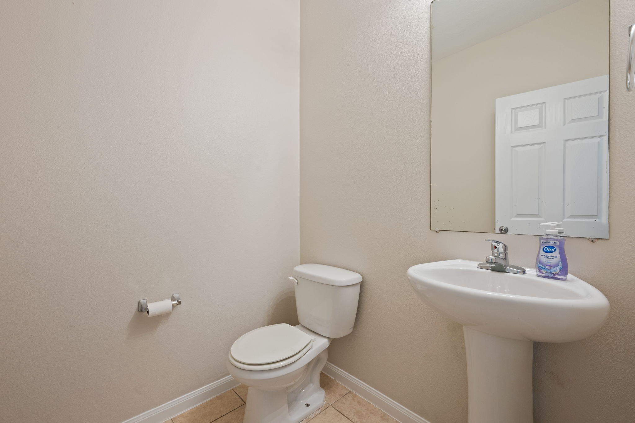 803 Marigold Road Baytown, TX 77521 - Photo 22 of 31 a bathroom with a sink a toilet and a mirror