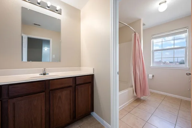 a bathroom with a double vanity sink and a mirror