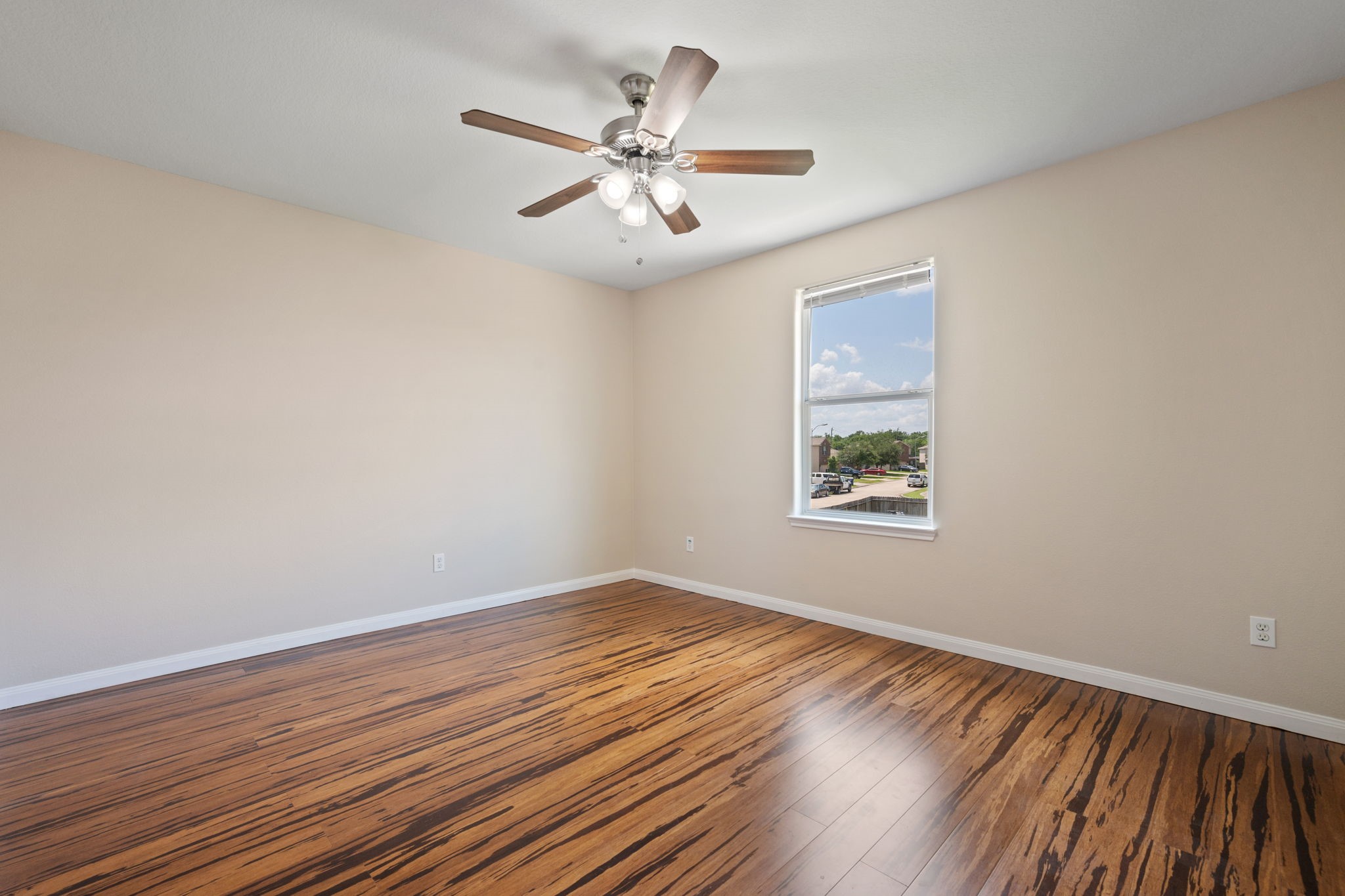 803 Marigold Road Baytown, TX 77521 - Photo 27 of 31 a view of an empty room with wooden floor and a window