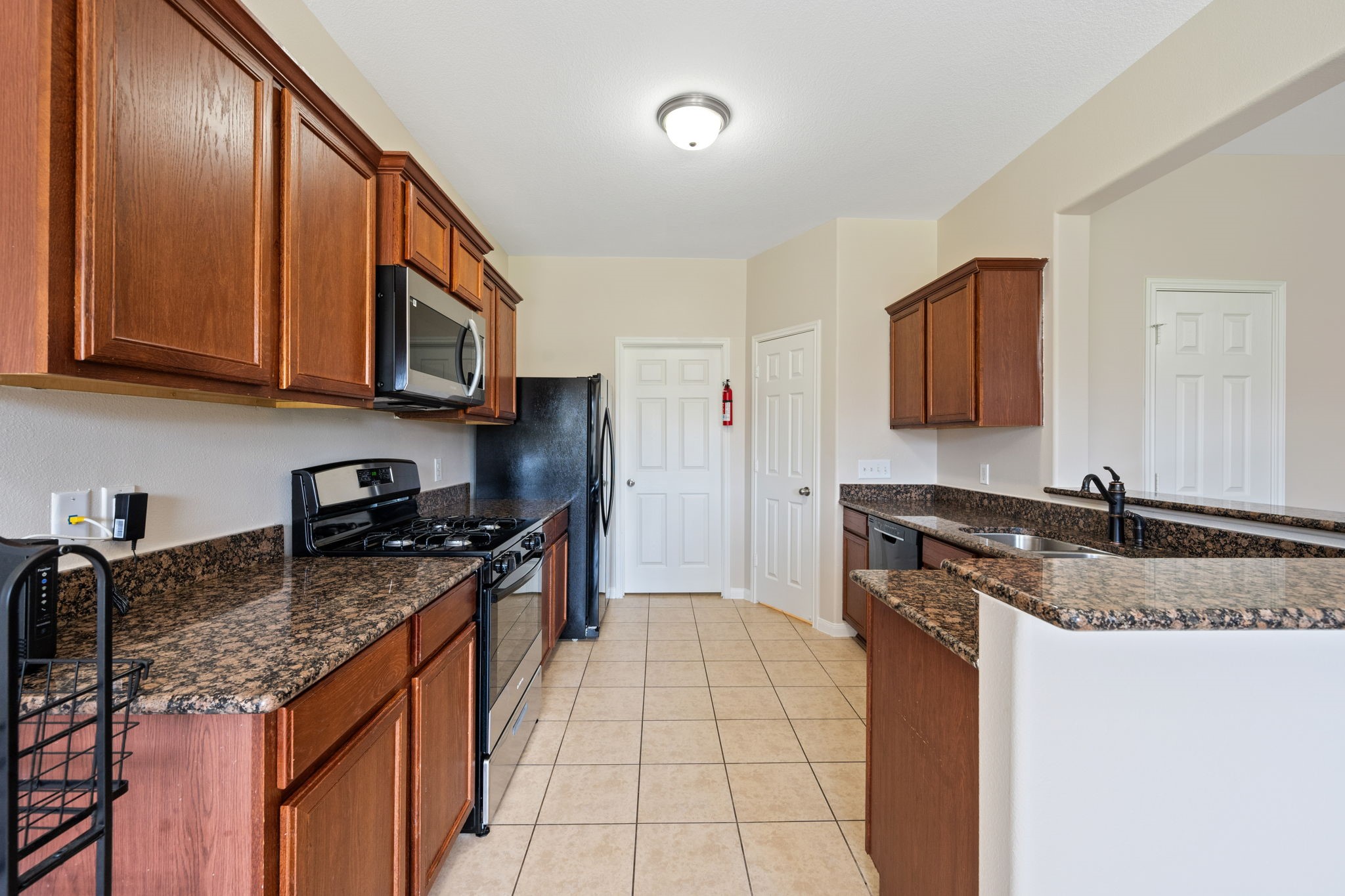 803 Marigold Road Baytown, TX 77521 - Photo 3 of 31 a kitchen with stainless steel appliances granite countertop a sink stove and cabinets