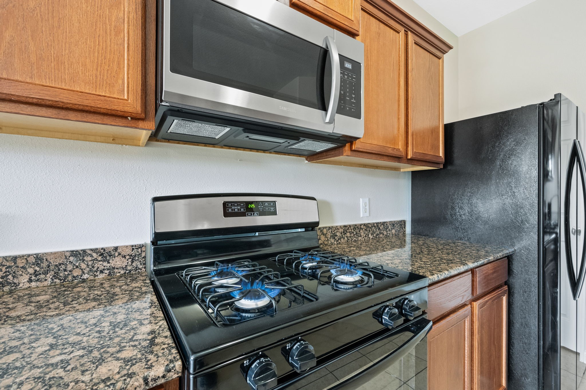 803 Marigold Road Baytown, TX 77521 - Photo 6 of 31 a kitchen with a stove and a microwave