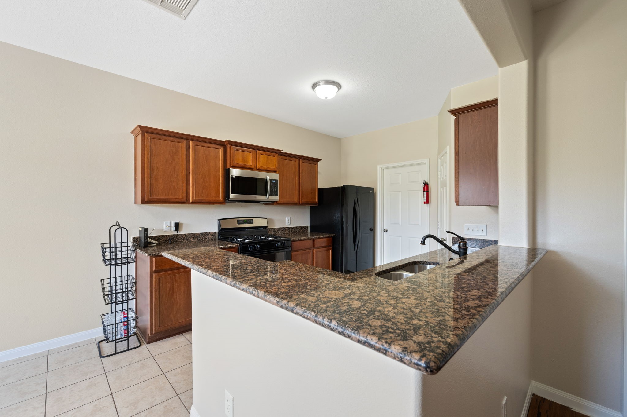 803 Marigold Road Baytown, TX 77521 - Photo 7 of 31 a kitchen with stainless steel appliances granite countertop a sink and a microwave