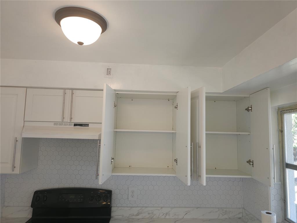 2720 North Avocado Road Avon Park, FL 33825 - Photo 15 of 35 a view of an empty room with a cabinet and window