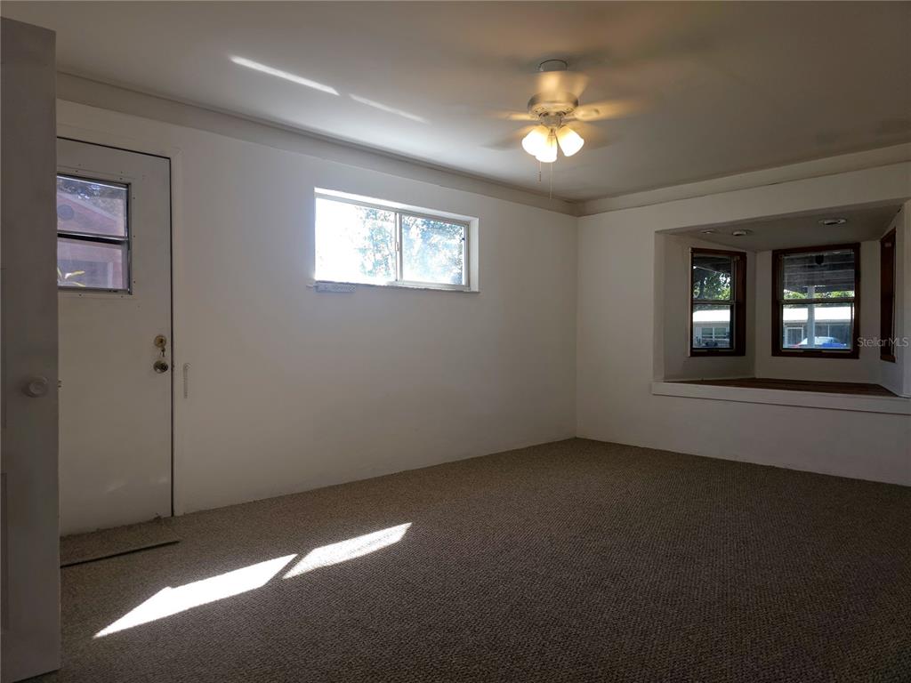 2720 North Avocado Road Avon Park, FL 33825 - Photo 17 of 35 a view of an empty room with window and chandelier fan