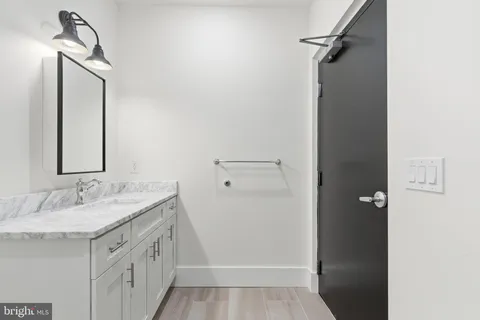 a bathroom with a sink a mirror and a shower