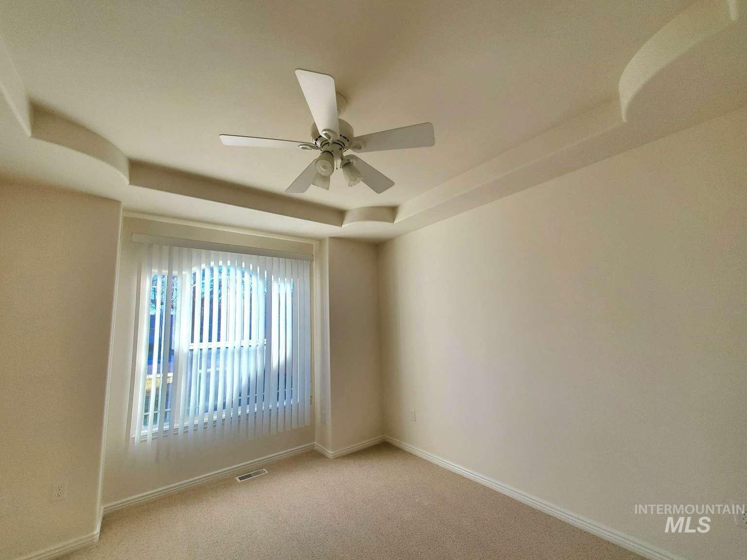1100 East Wright Street Boise, ID 83706 - Photo 12 of 25 Recessed tray ceiling featuring a central ceiling fan