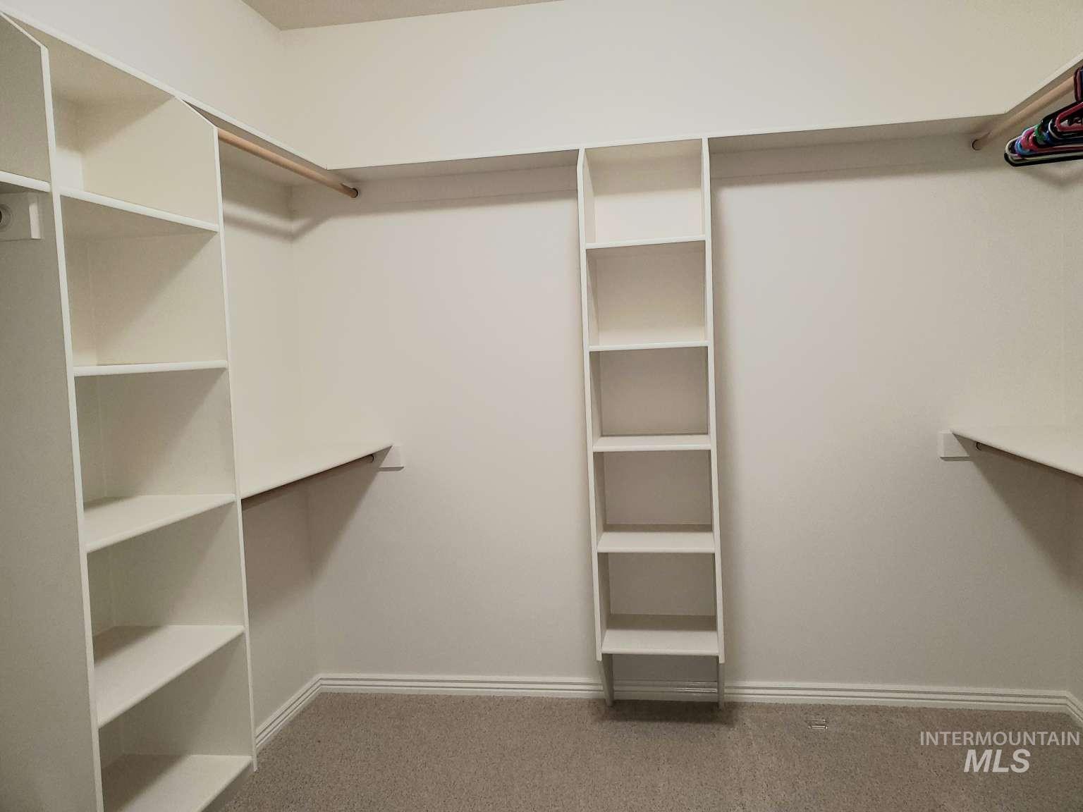 1100 East Wright Street Boise, ID 83706 - Photo 18 of 25 Custom closet system featuring built-in shelving, hanging rods, and perimeter shelving