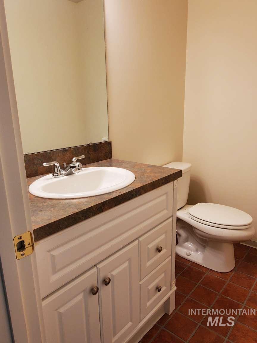 1100 East Wright Street Boise, ID 83706 - Photo 24 of 25 Bathroom featuring vanity and dark tile patterned flooring