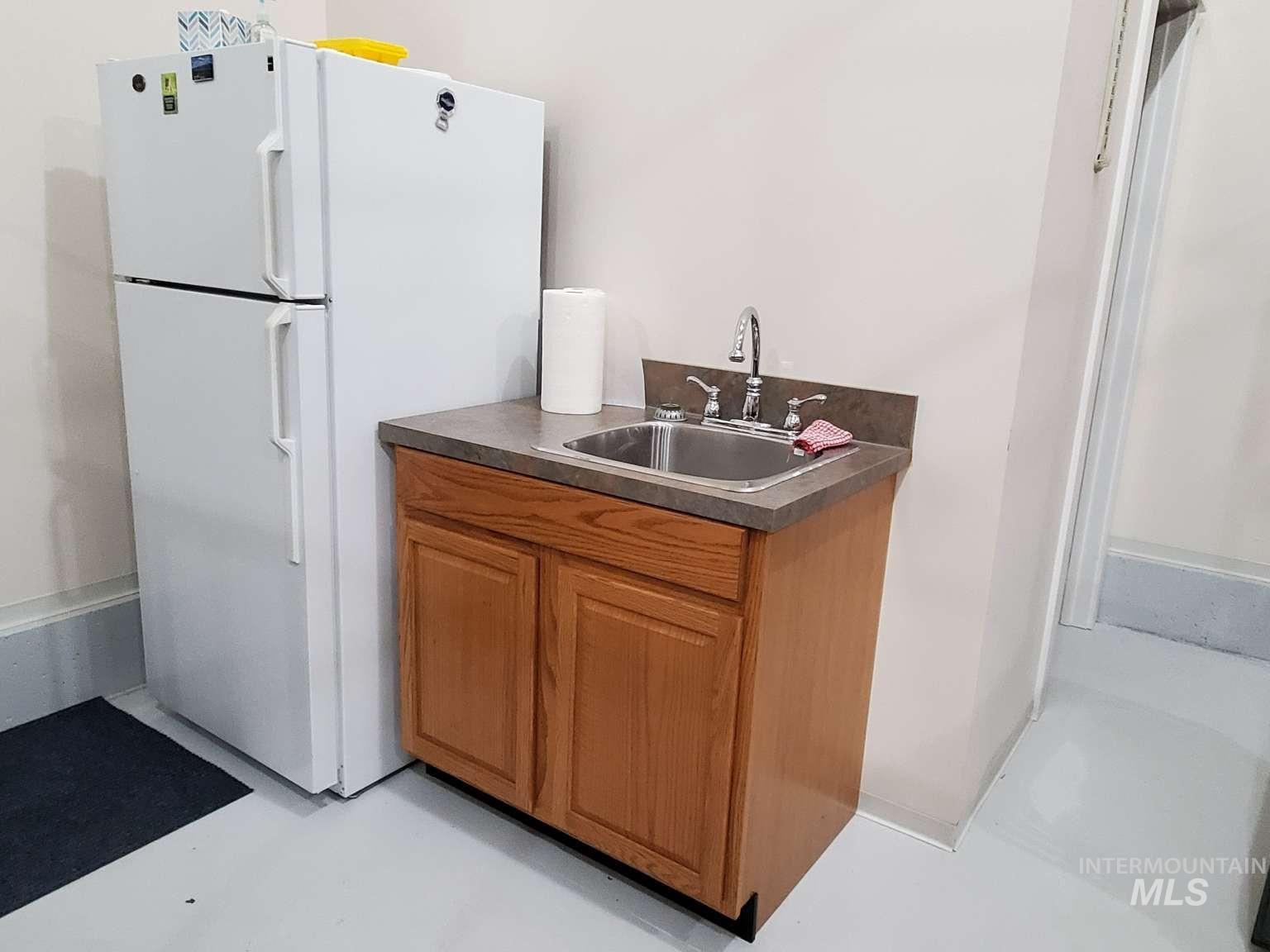 1100 East Wright Street Boise, ID 83706 - Photo 25 of 25 Utility area featuring a built-in cabinet with a laminate countertop, stainless steel sink, and chrome faucet
