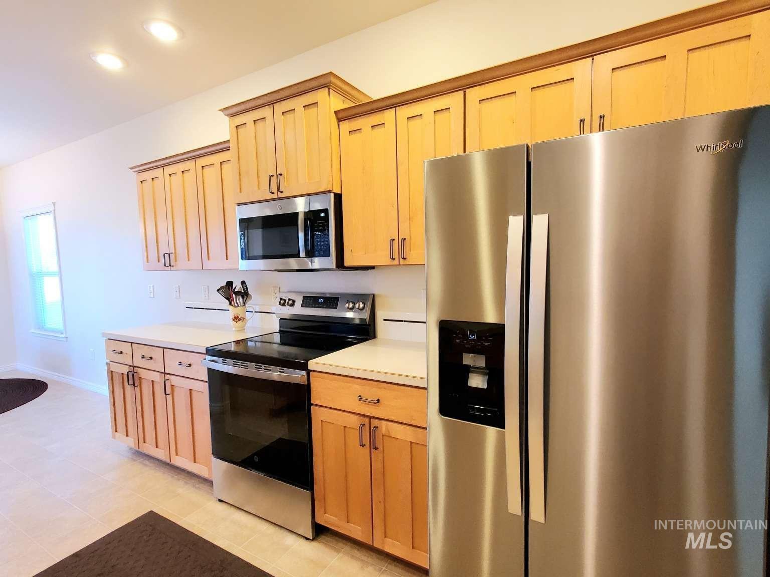 1100 East Wright Street Boise, ID 83706 - Photo 5 of 25 Kitchen featuring stainless steel appliances, light countertops, light brown cabinetry, and recessed lighting