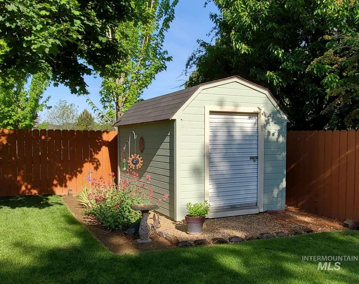 1100 East Wright Street Boise, ID 83706 - Photo 5 of 25 Outdoor storage shed featuring a gambrel roof and light green siding
