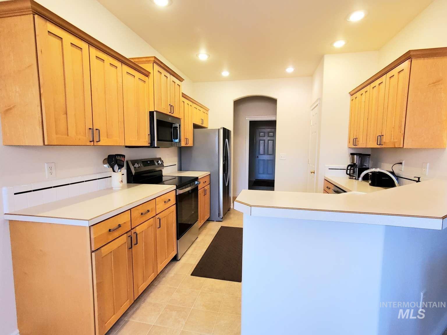 1100 East Wright Street Boise, ID 83706 - Photo 6 of 25 Kitchen with stainless steel appliances, light countertops, a peninsula, recessed lighting, and light tile patterned floors