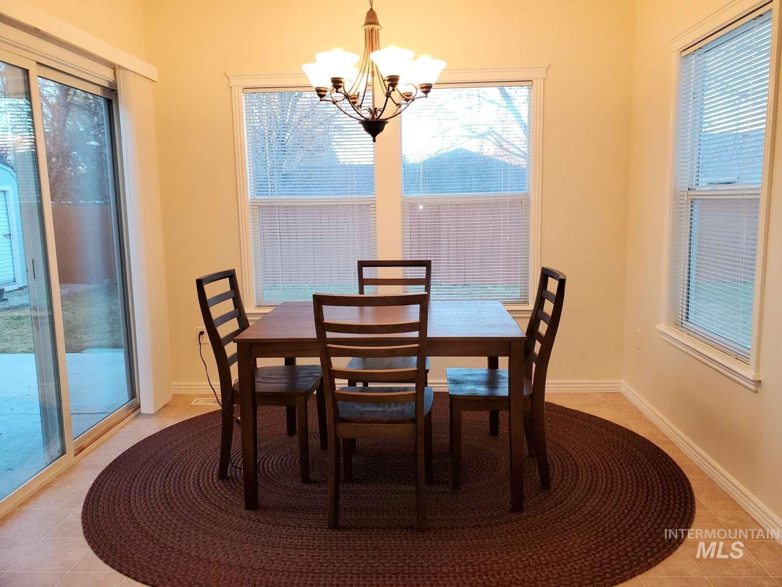 1100 East Wright Street Boise, ID 83706 - Photo 8 of 25 Dining area with light tile patterned floors and a chandelier