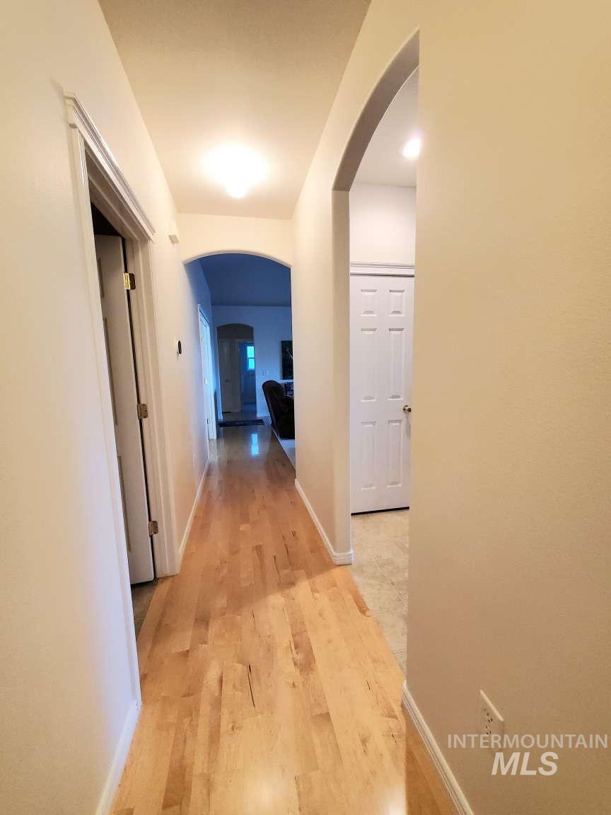 1100 East Wright Street Boise, ID 83706 - Photo 9 of 25 Corridor featuring arched walkways and light wood-style floors