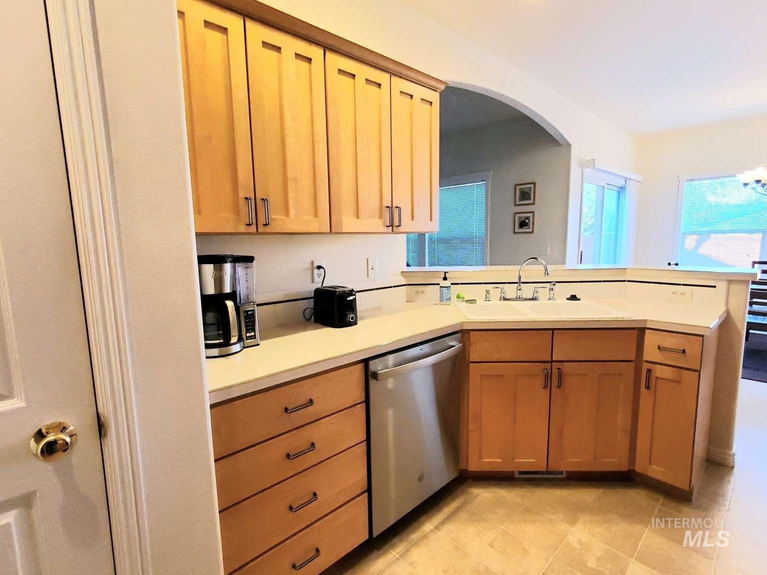 1100 East Wright Street Boise, ID 83706 - Photo 10 of 25 Kitchen featuring light wood cabinetry, white countertops, a double basin sink with a chrome faucet, and tile flooring