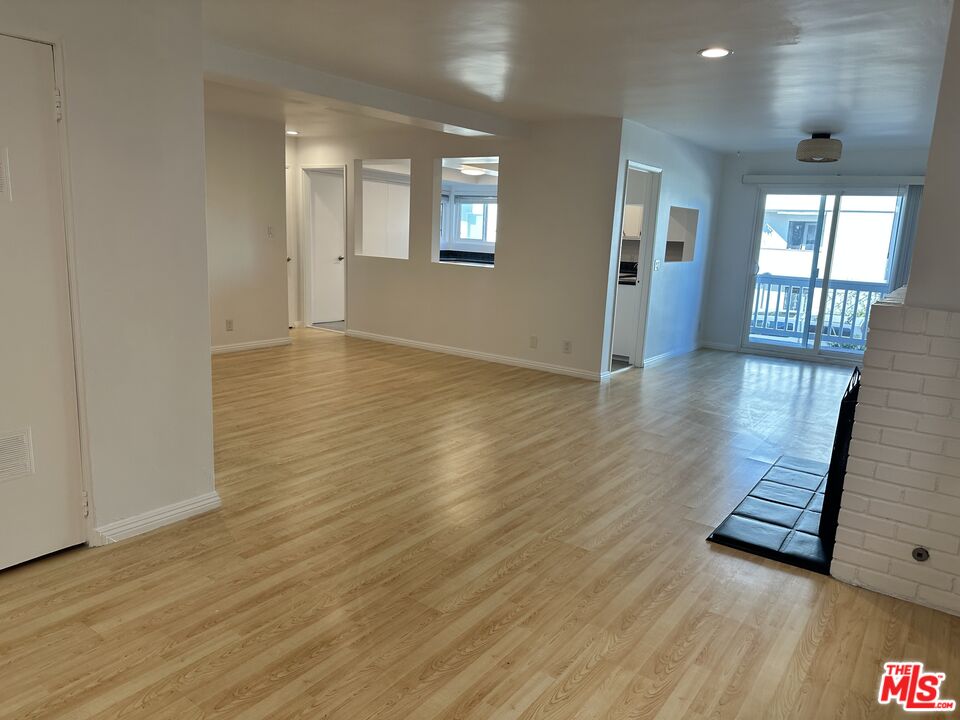 24 Lighthouse Street, Unit A Marina del Rey, CA 90292 - Photo 14 of 39 an empty room with wooden floor and windows