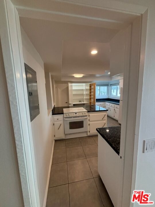 24 Lighthouse Street, Unit A Marina del Rey, CA 90292 - Photo 19 of 39 a kitchen with granite countertop a refrigerator and a stove top oven