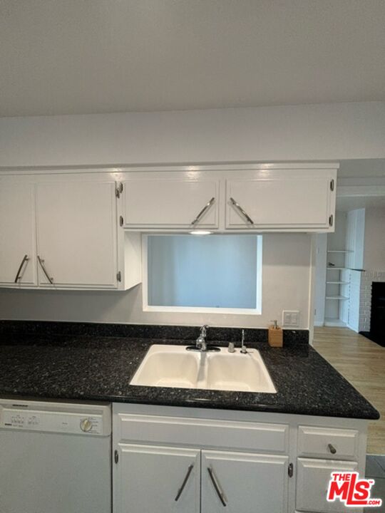 24 Lighthouse Street, Unit A Marina del Rey, CA 90292 - Photo 27 of 39 a bathroom with a granite countertop sink and white cabinets