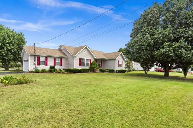 a front view of house with yard and trees