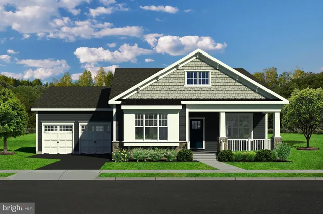 a front view of a house with a garden and yard