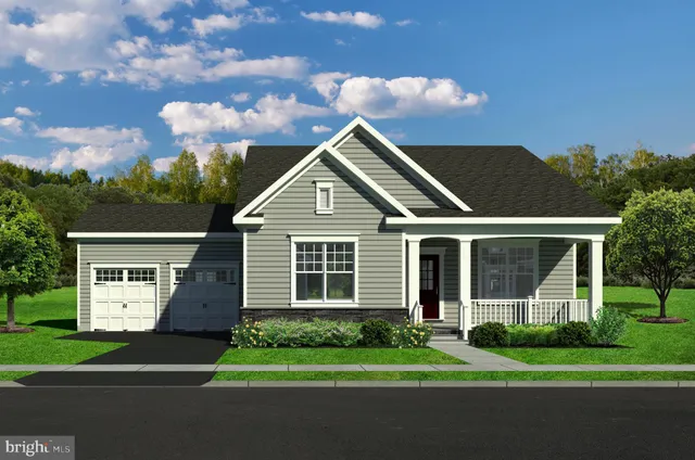a front view of a house with a garden and plants
