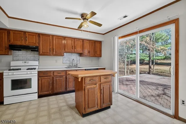 a kitchen with stainless steel appliances granite countertop a stove sink and cabinets
