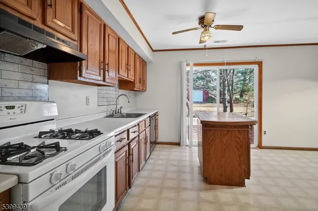 a kitchen with stainless steel appliances granite countertop a stove and a sink