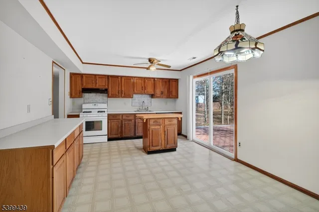 a kitchen with stainless steel appliances a stove a sink and a refrigerator