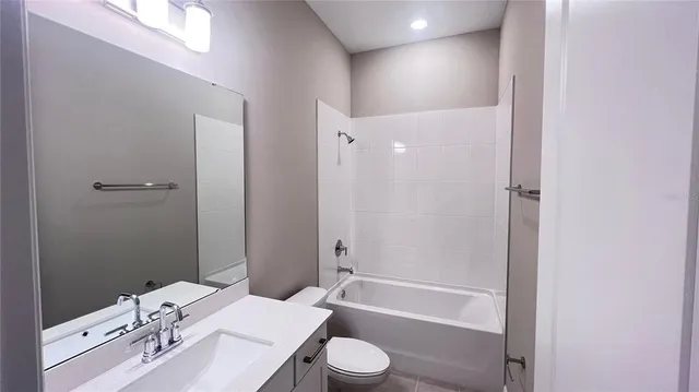 a bathroom with a sink toilet vanity and shower