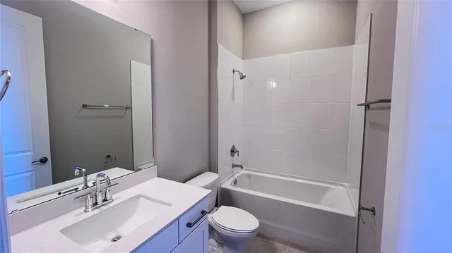 a bathroom with a sink toilet vanity and shower