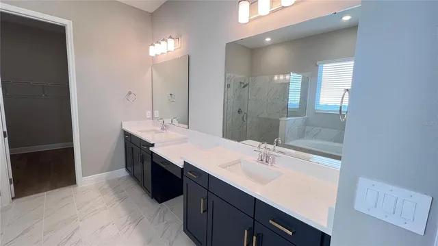 a bathroom with a sink double vanity and a mirror