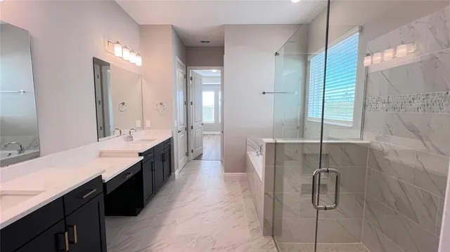 a large bathroom with a double vanity sink and a mirror