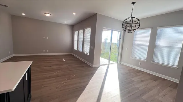 a view of an entryway with wooden floor