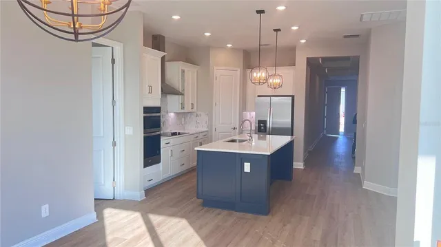 a kitchen with a sink appliances and cabinets
