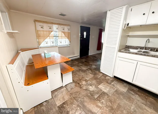 a view of kitchen with a sink and wooden floor