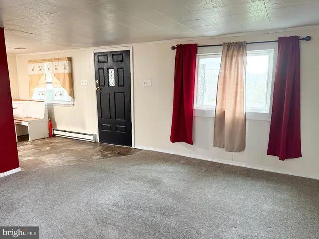 an empty room with windows and closet