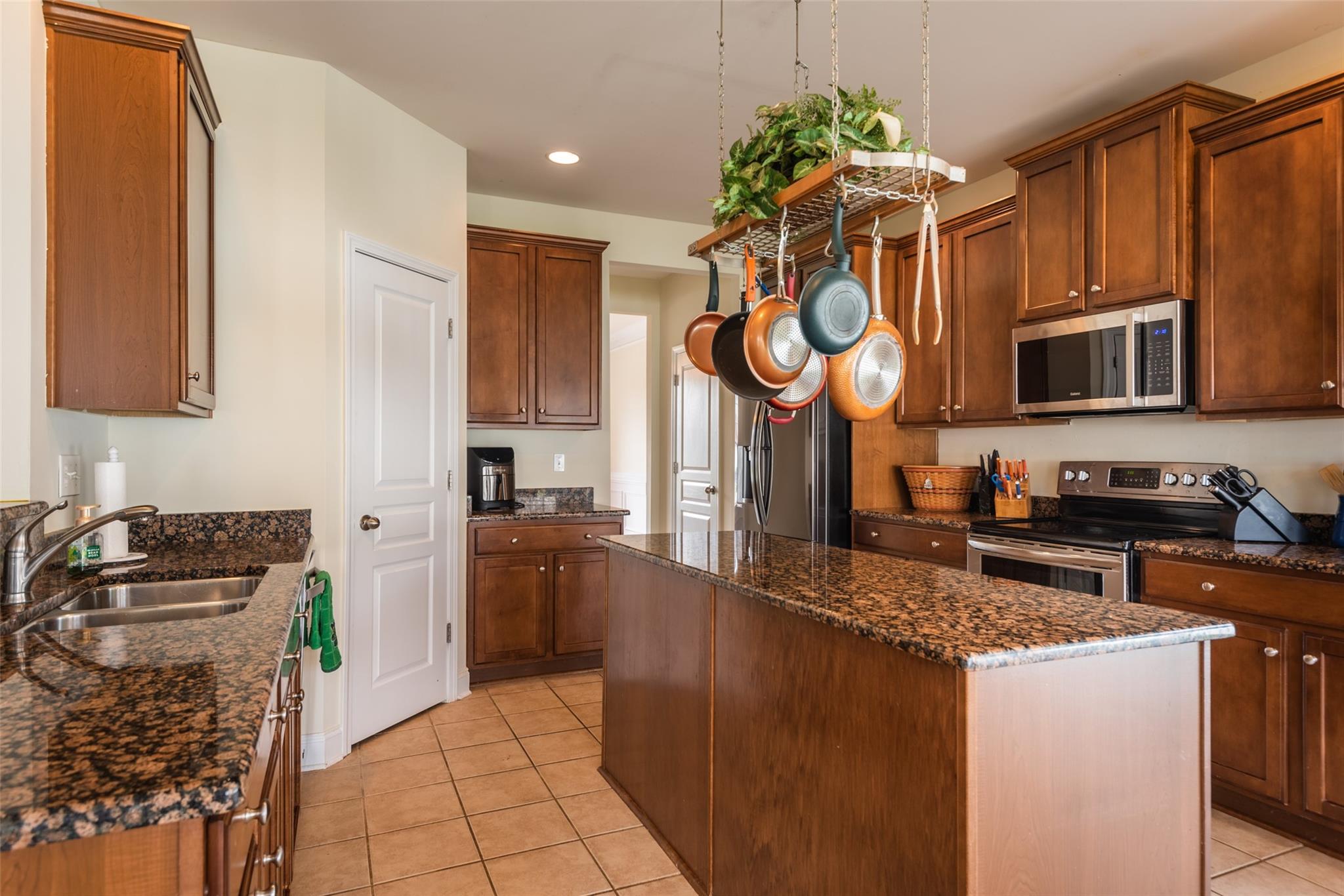2012 Apogee Drive Indian Trail, NC 28079 - Photo 12 of 28 a kitchen with stainless steel appliances granite countertop a stove a sink and a microwave