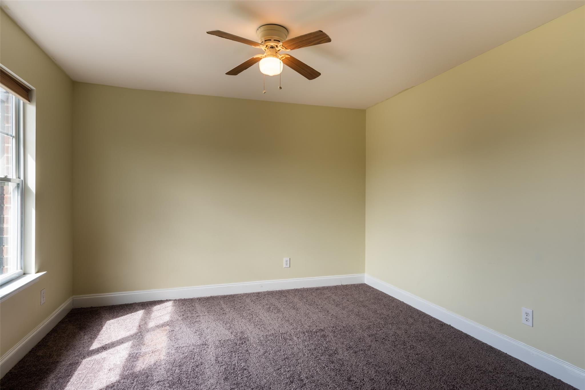2012 Apogee Drive Indian Trail, NC 28079 - Photo 16 of 28 an empty room with a window and a fan
