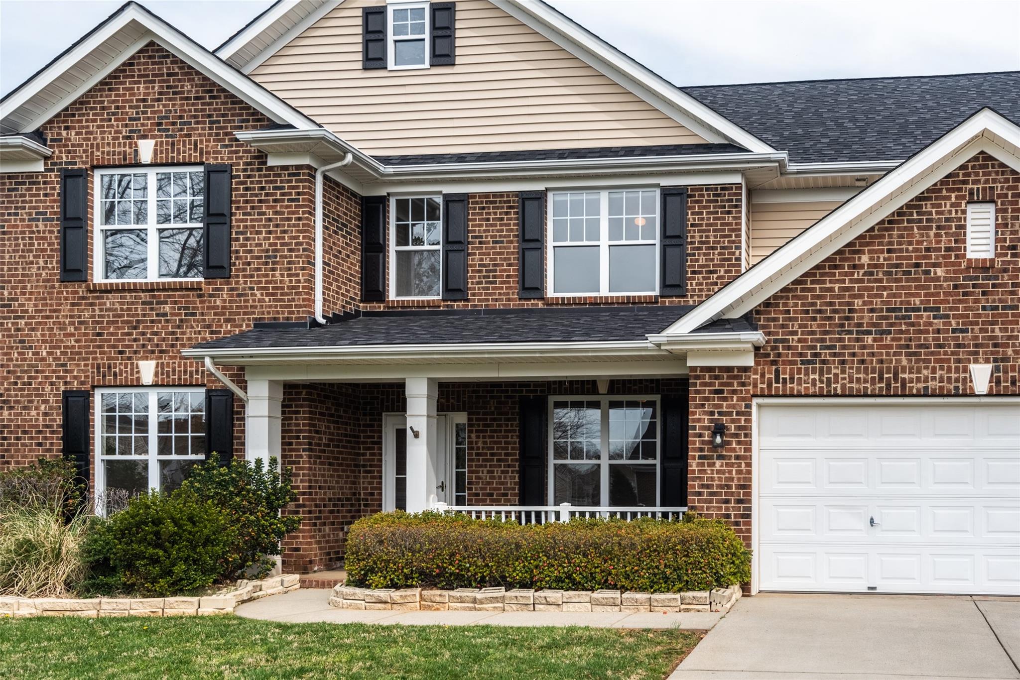 2012 Apogee Drive Indian Trail, NC 28079 - Photo 4 of 28 a front view of a house with garden and porch