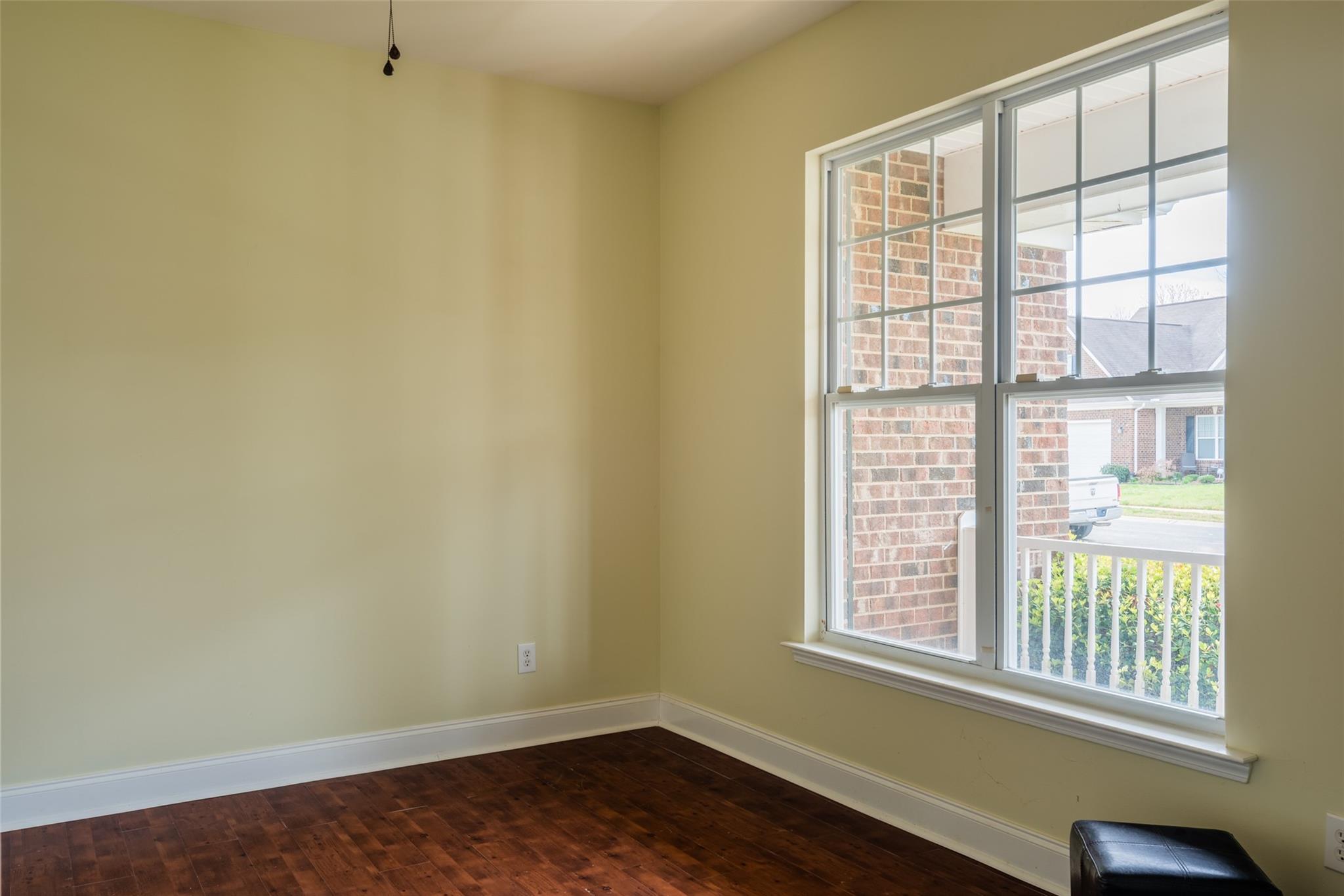 2012 Apogee Drive Indian Trail, NC 28079 - Photo 7 of 28 an empty room with wooden floor and windows