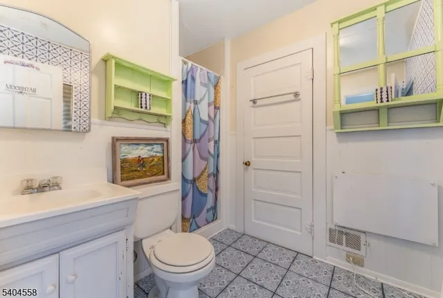 a bathroom with a toilet and a shower curtain