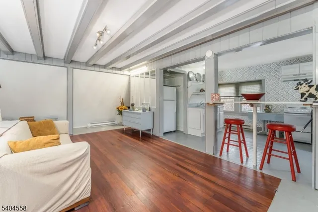a bedroom with furniture and wooden floor