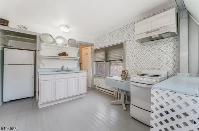 a kitchen with a sink and a stove top oven